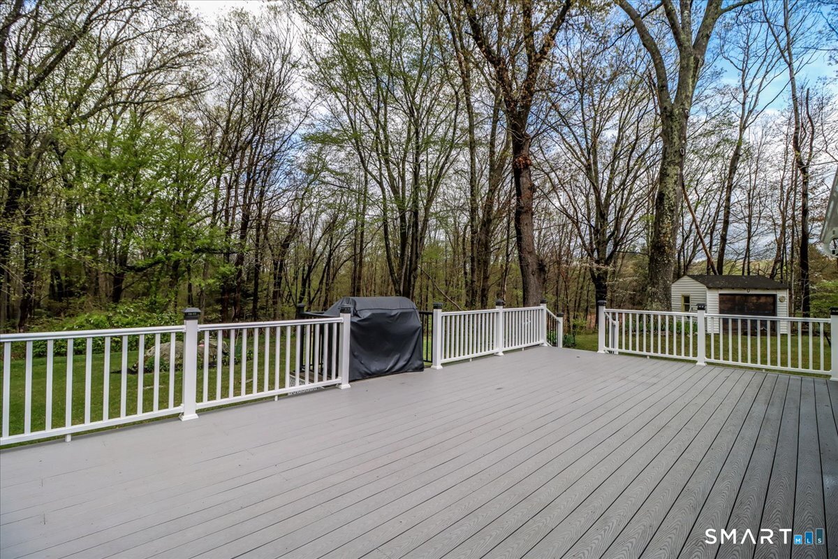 4 Farrell Road Newtown, CT 06470 - Photo 33 of 36 a view of a deck with a large trees and wooden fence