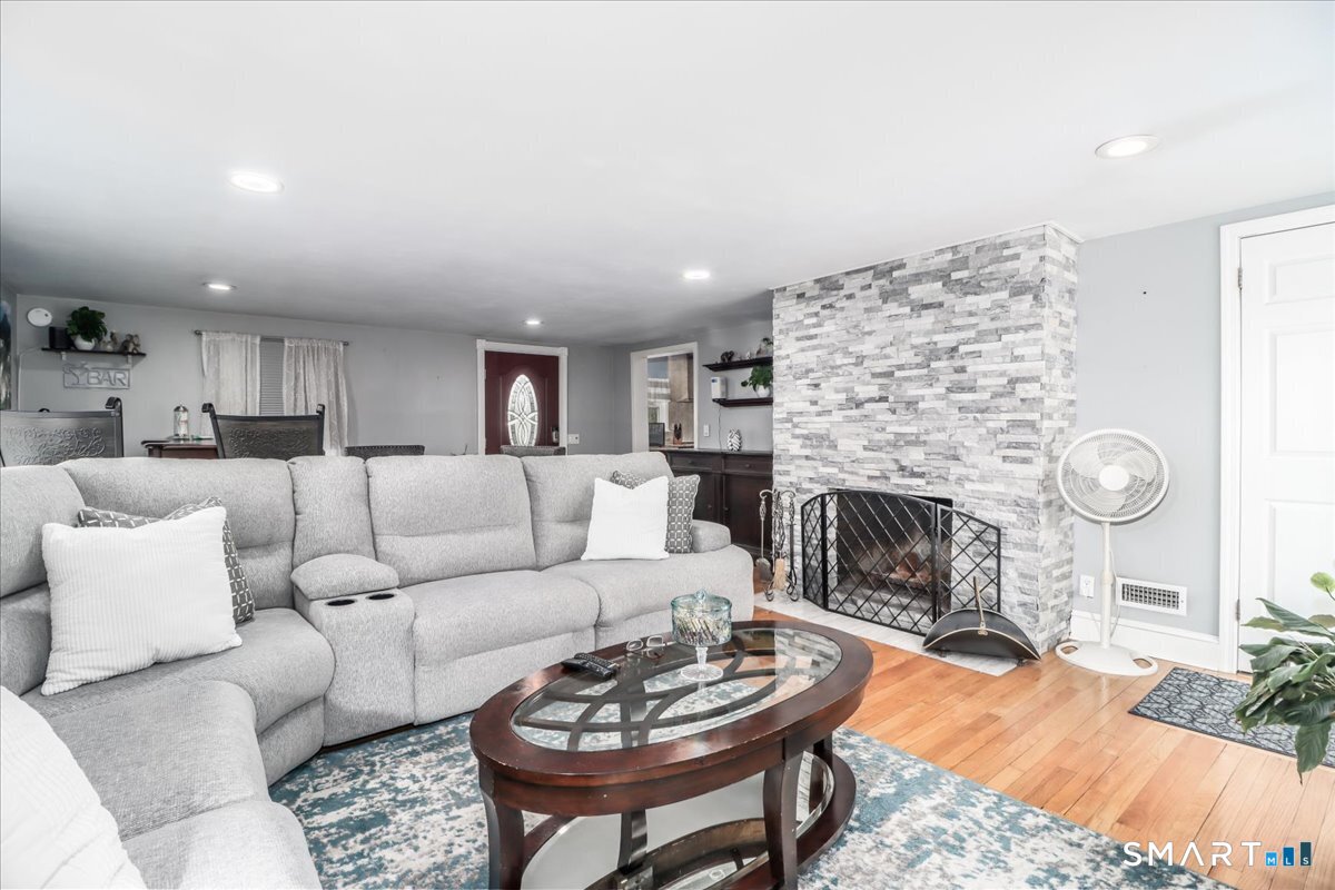 4 Farrell Road Newtown, CT 06470 - Photo 6 of 36 a living room with furniture a fireplace and a table