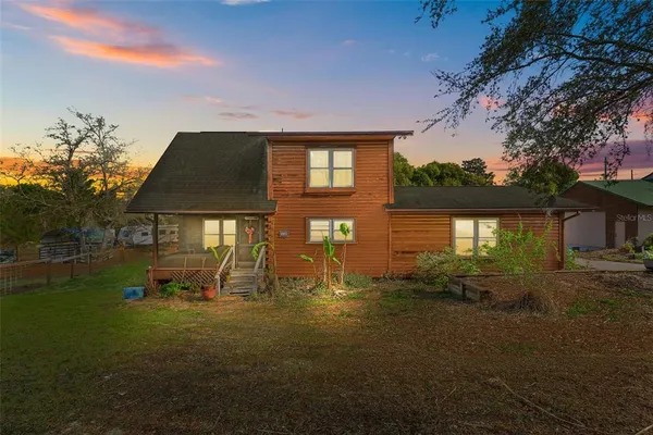 a backyard of a house with table and chairs