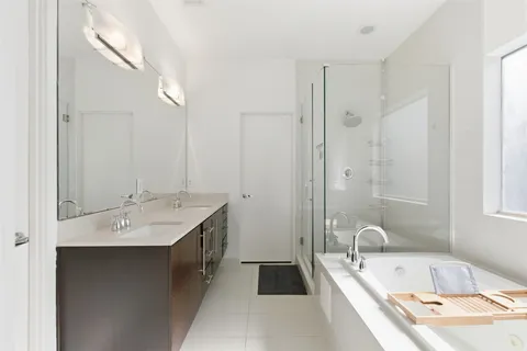 a bathroom with a tub sink and mirror