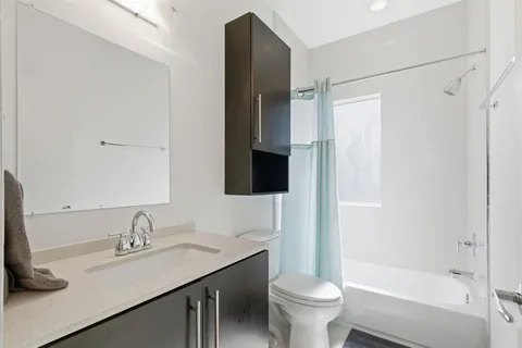 a bathroom with a sink toilet and shower