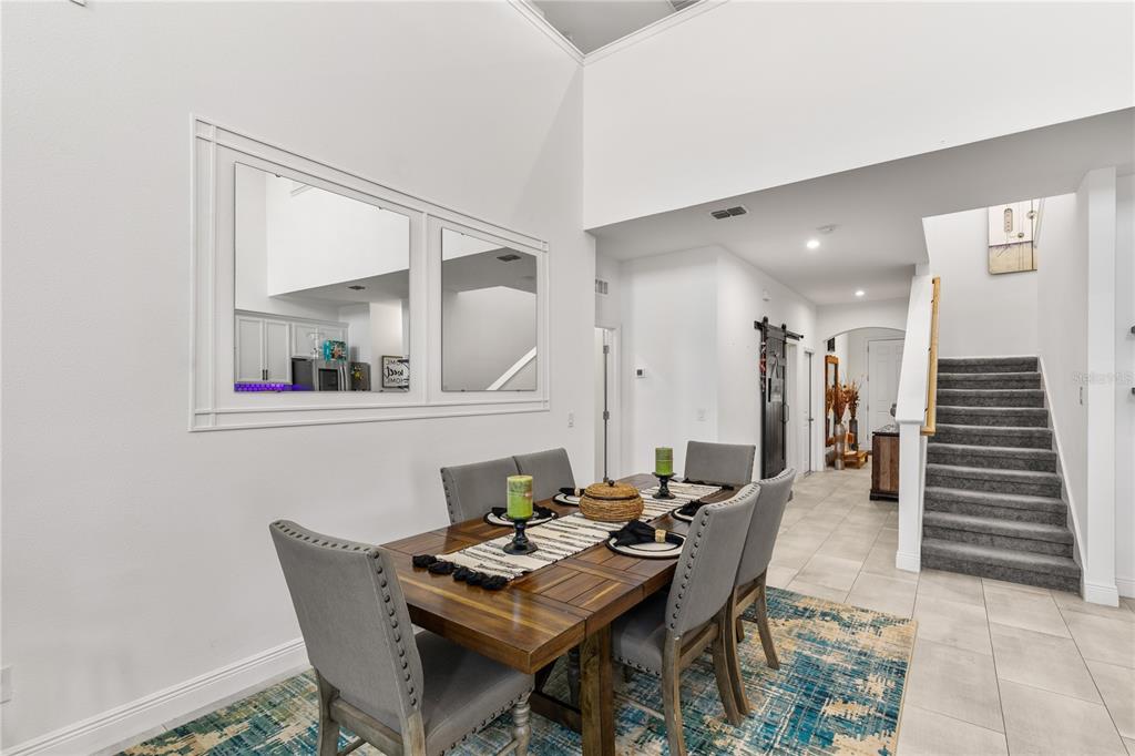 5637 Beggs Road St. Cloud, FL 34771 - Photo 5 of 35 a view of a dining room with furniture and wooden floor