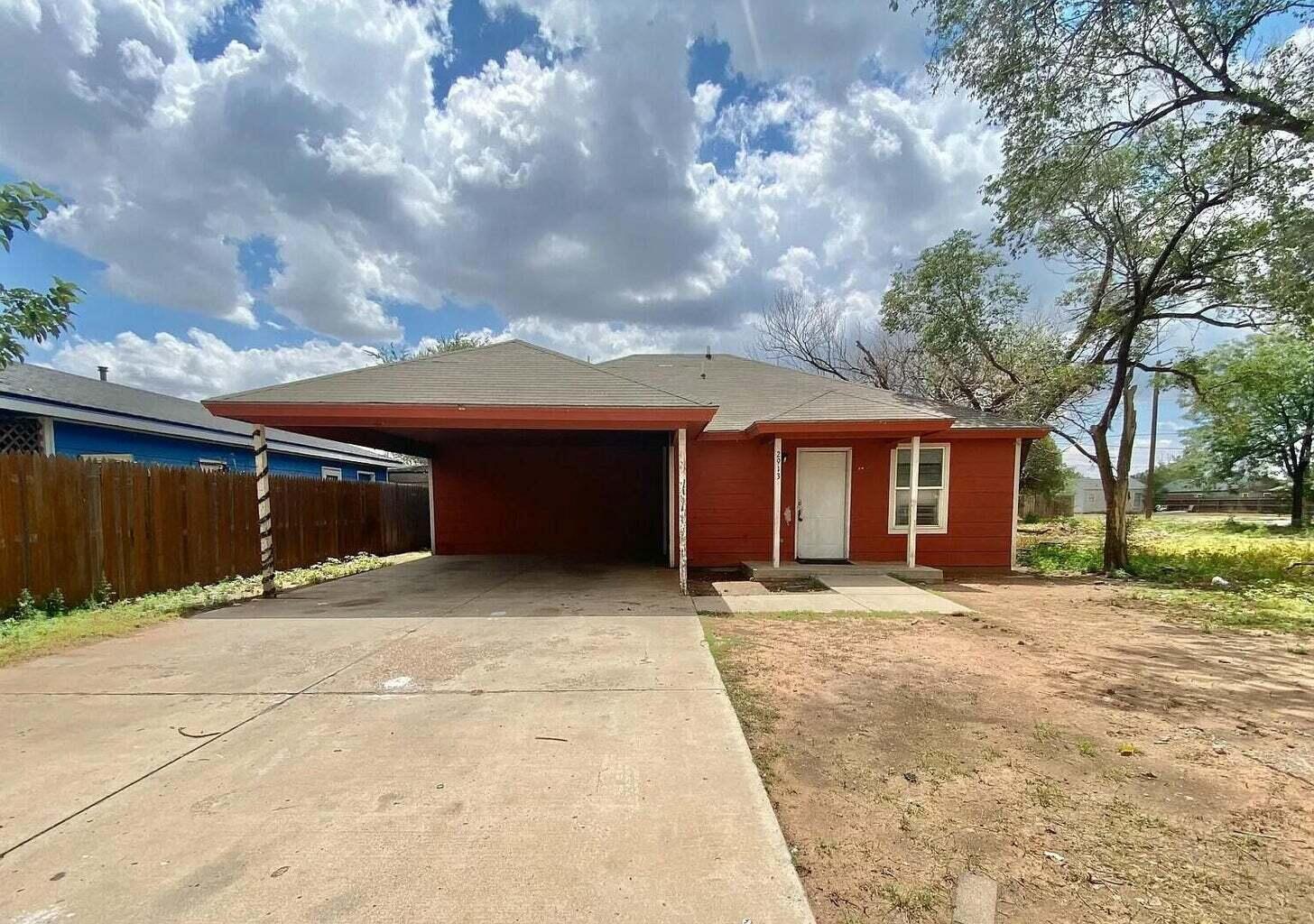 2913 Bates Street Lubbock, TX 79415 - Photo 1 of 9 a front view of a house with a yard and garage