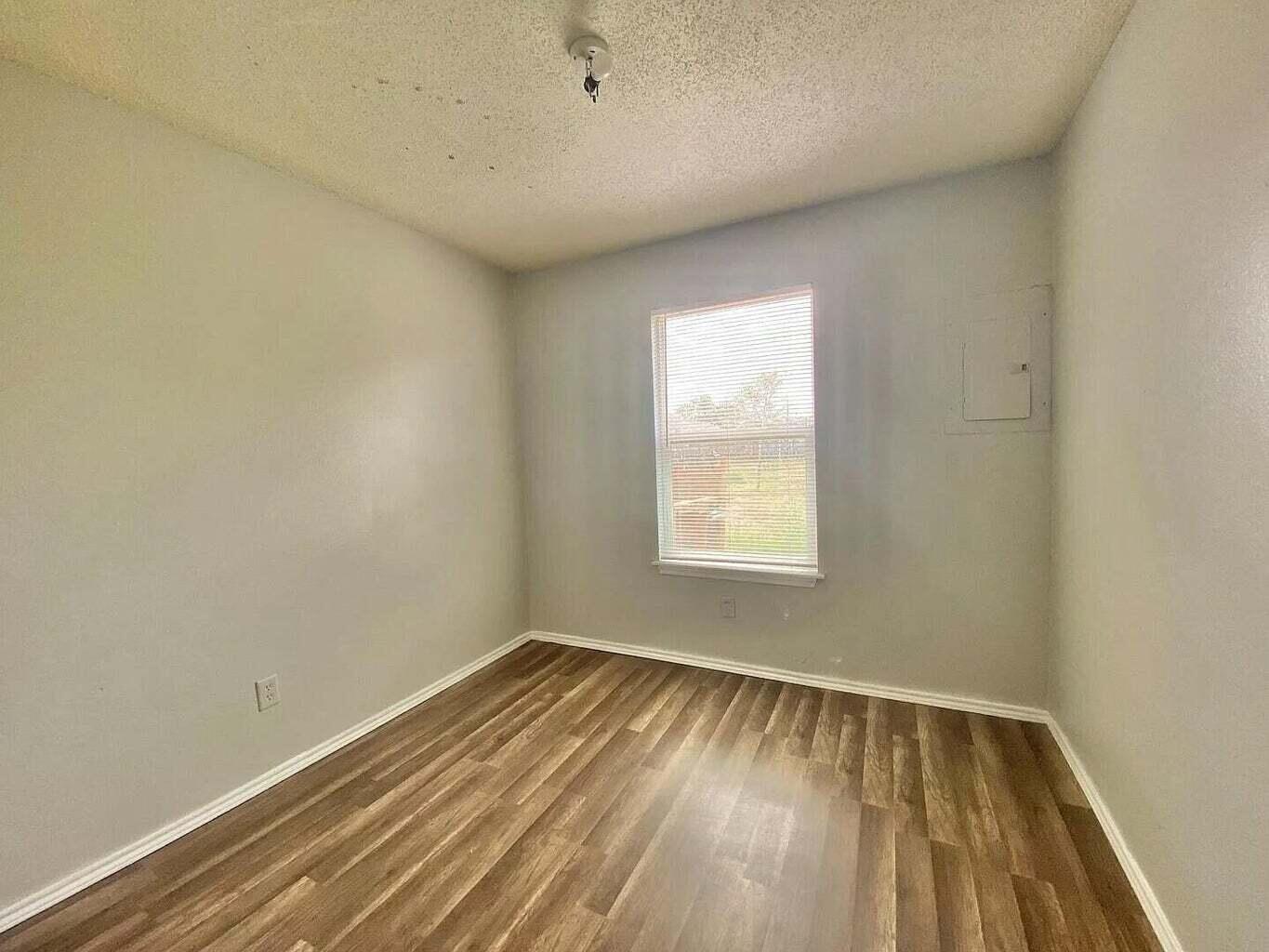 2913 Bates Street Lubbock, TX 79415 - Photo 5 of 9 an empty room with a window
