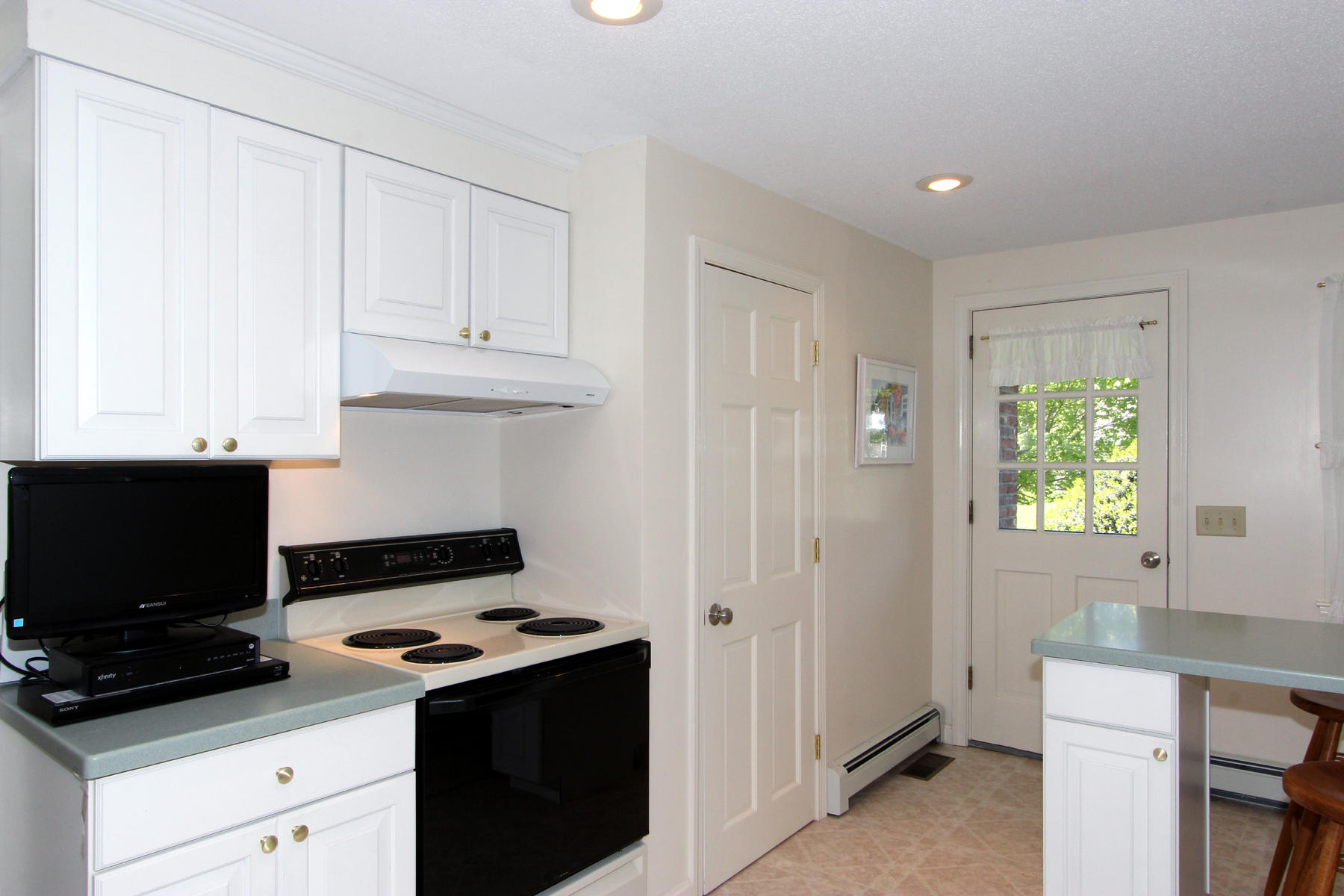 167 Ambergris Circle Brewster, MA 02631 - Photo 8 of 28 a kitchen with cabinets appliances and a window