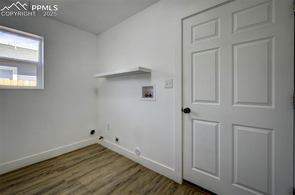 1436 Brewery Road Pueblo, CO 81001 - Photo 17 of 40 Laundry area featuring baseboards, washer hookup, laundry area, and dark wood-type flooring