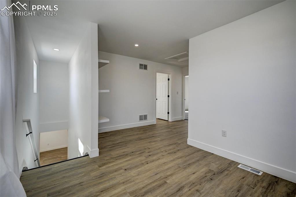 1436 Brewery Road Pueblo, CO 81001 - Photo 23 of 40 Empty room featuring baseboards, visible vents, and wood finished floors
