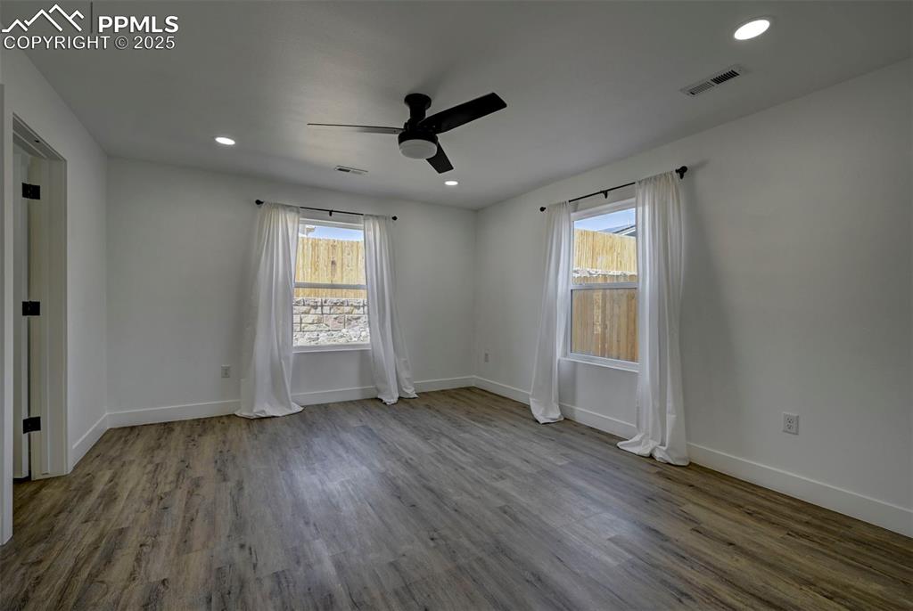 1436 Brewery Road Pueblo, CO 81001 - Photo 25 of 40 Unfurnished room with plenty of natural light, visible vents, wood finished floors, and a ceiling fan