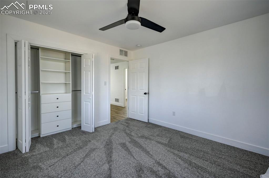 1436 Brewery Road Pueblo, CO 81001 - Photo 29 of 40 Unfurnished bedroom with a closet, baseboards, dark carpet, and visible vents