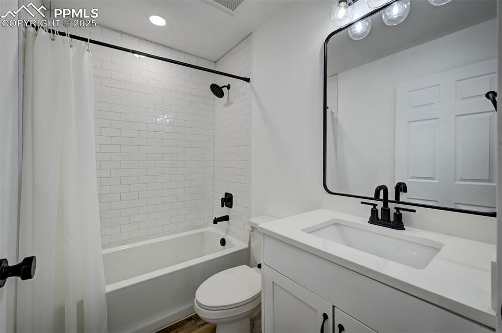 1436 Brewery Road Pueblo, CO 81001 - Photo 31 of 40 Bathroom featuring shower / bath combination with curtain, toilet, and vanity