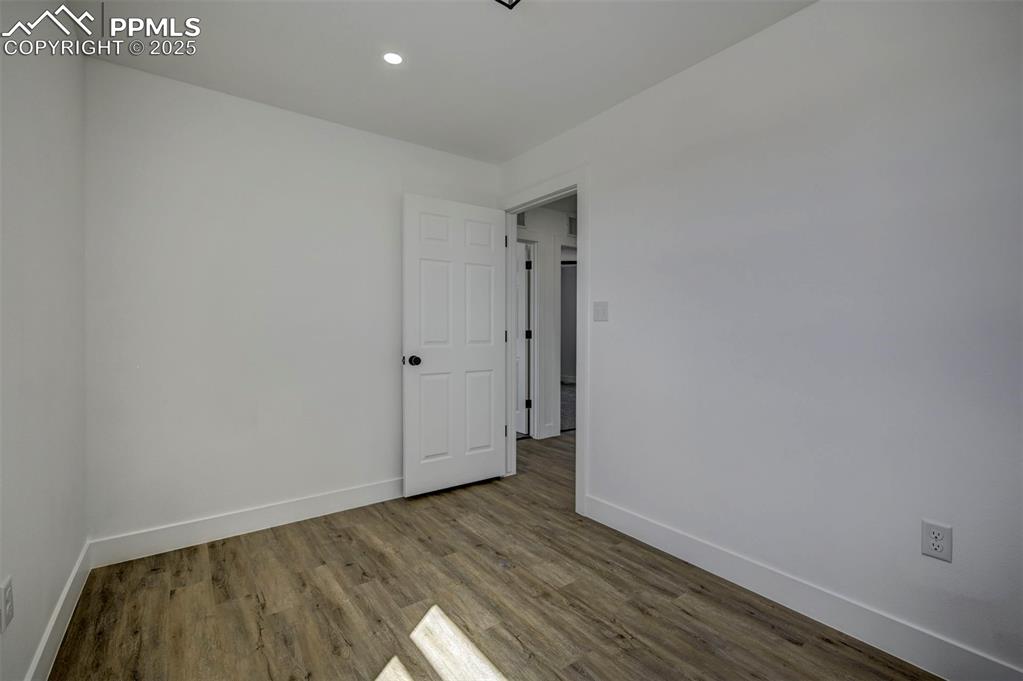 1436 Brewery Road Pueblo, CO 81001 - Photo 32 of 40 Unfurnished room featuring baseboards, wood finished floors, and recessed lighting