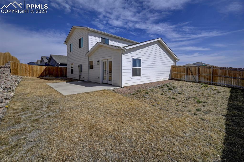 1436 Brewery Road Pueblo, CO 81001 - Photo 34 of 40 Rear view of property with a patio, a fenced backyard, and french doors