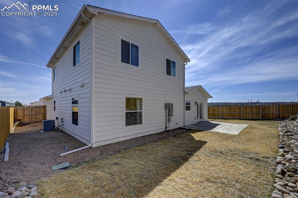1436 Brewery Road Pueblo, CO 81001 - Photo 35 of 40 Back of property with a fenced backyard, cooling unit, and a patio area