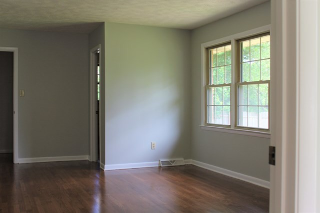 1148 Whiskey Road Aiken, SC 29801 - Photo 6 of 20 an empty room with wooden floor and windows