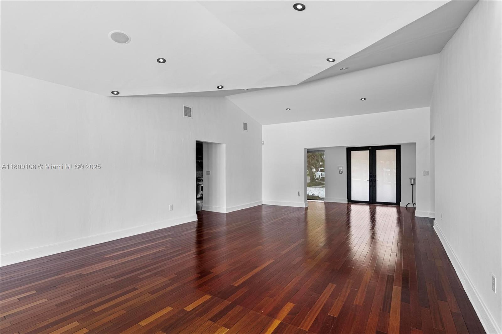 12605 Cyprus Road North Miami, FL 33181 - Photo 11 of 60 a view of an empty room with wooden floor and a window