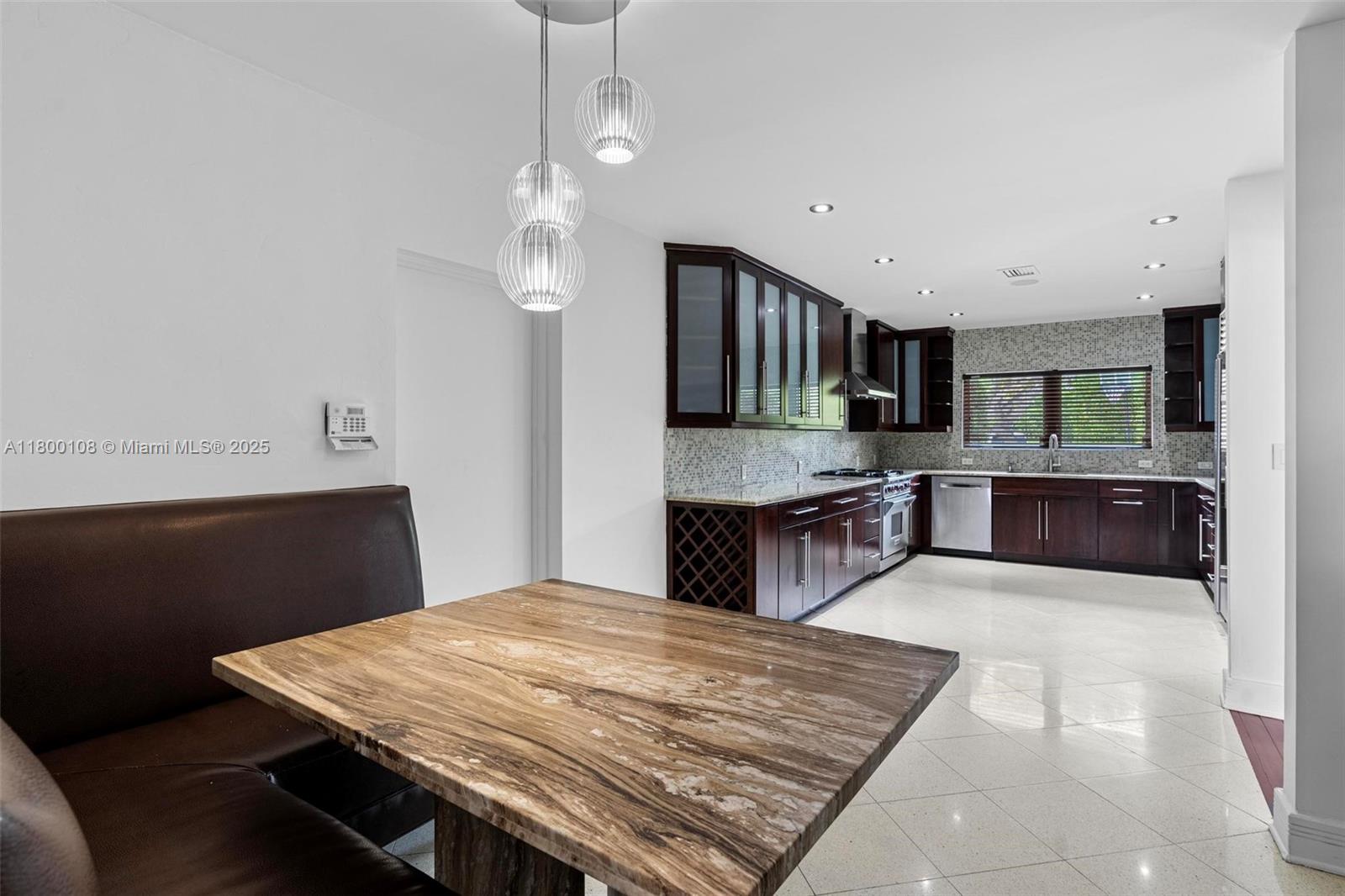 12605 Cyprus Road North Miami, FL 33181 - Photo 12 of 60 a large kitchen with kitchen island a sink stainless steel appliances and cabinets