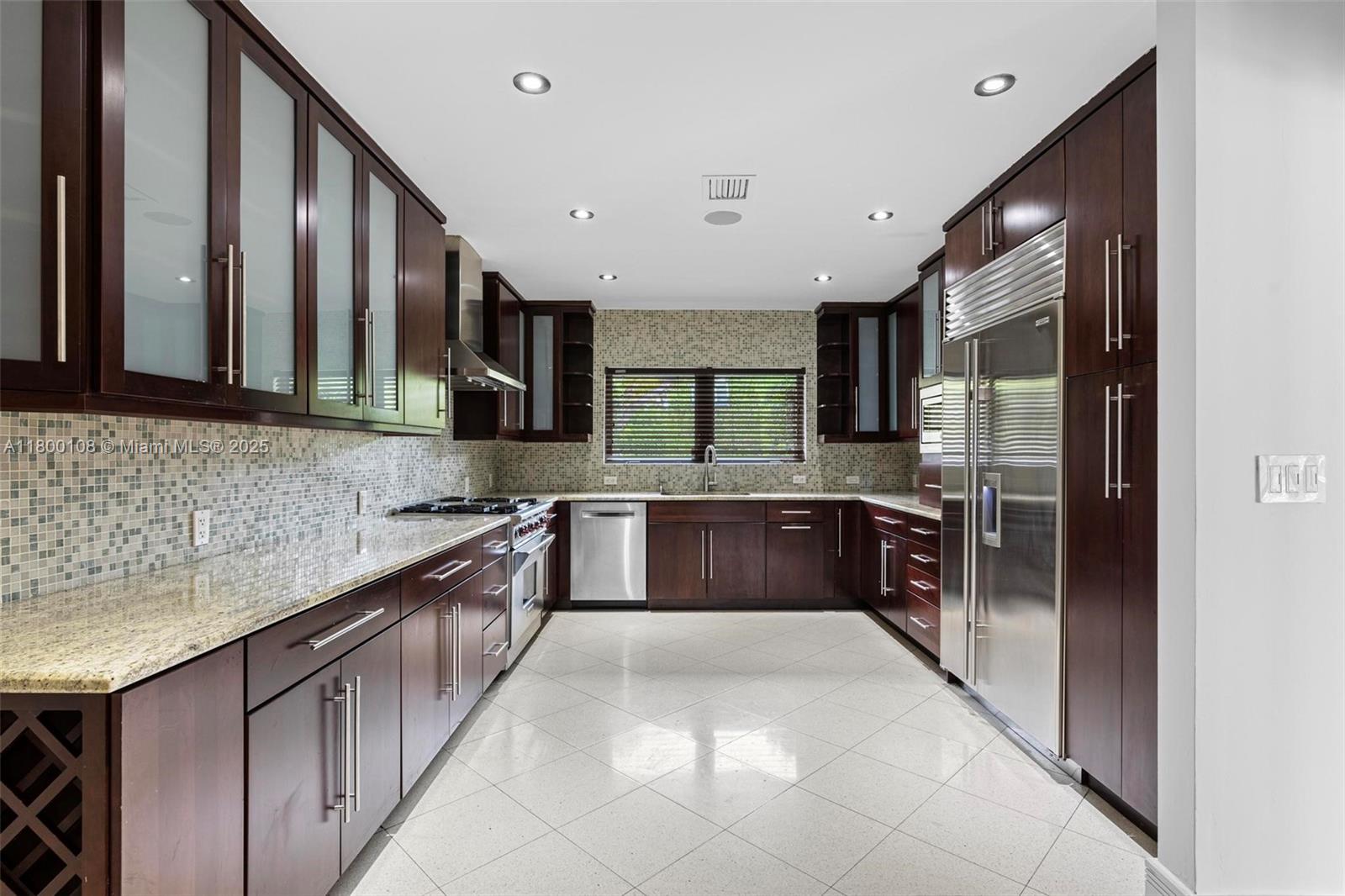 12605 Cyprus Road North Miami, FL 33181 - Photo 13 of 60 a large kitchen with granite countertop a large counter top stainless steel appliances and cabinets