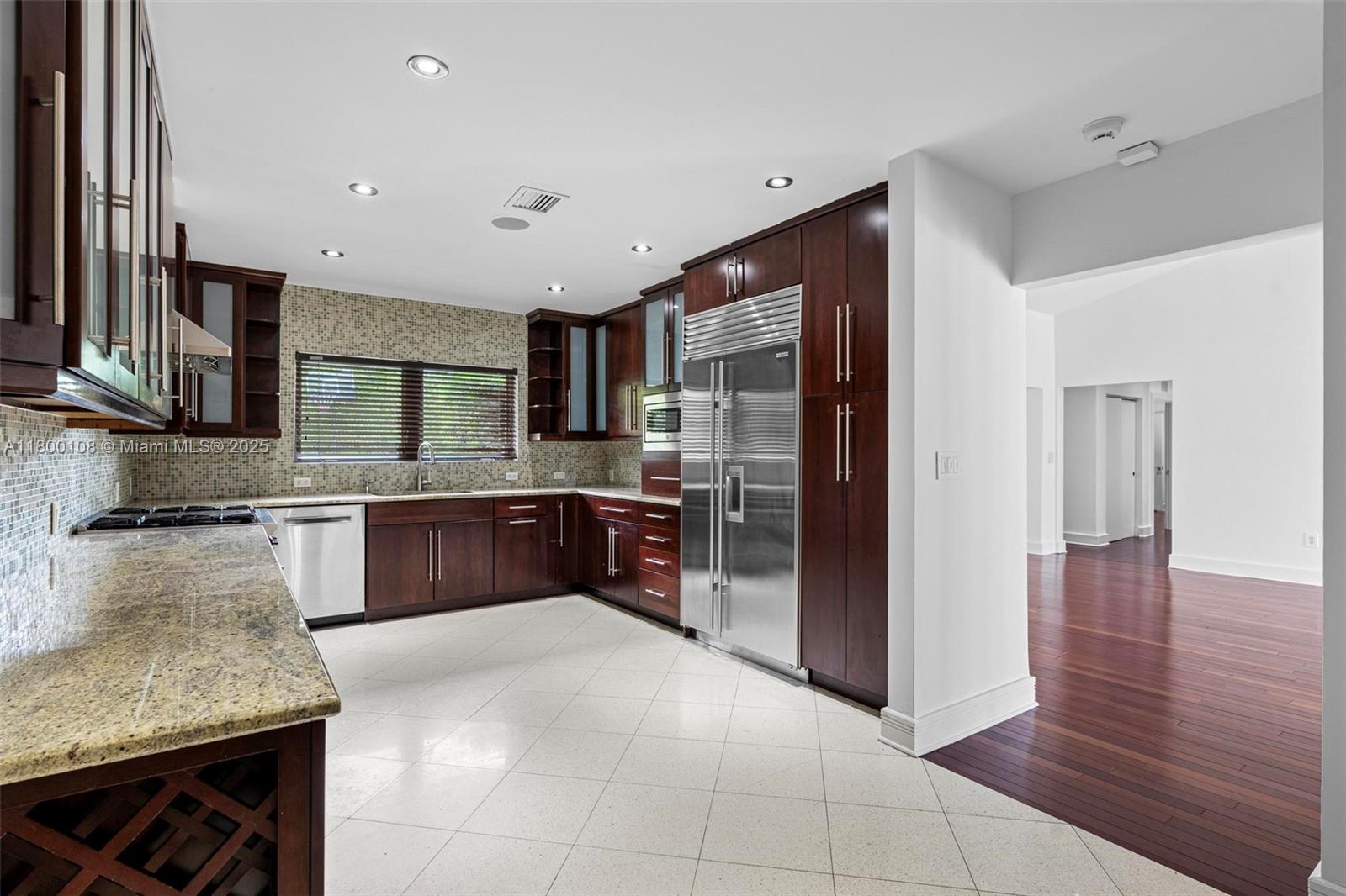 12605 Cyprus Road North Miami, FL 33181 - Photo 14 of 60 a large kitchen with stainless steel appliances and a refrigerator