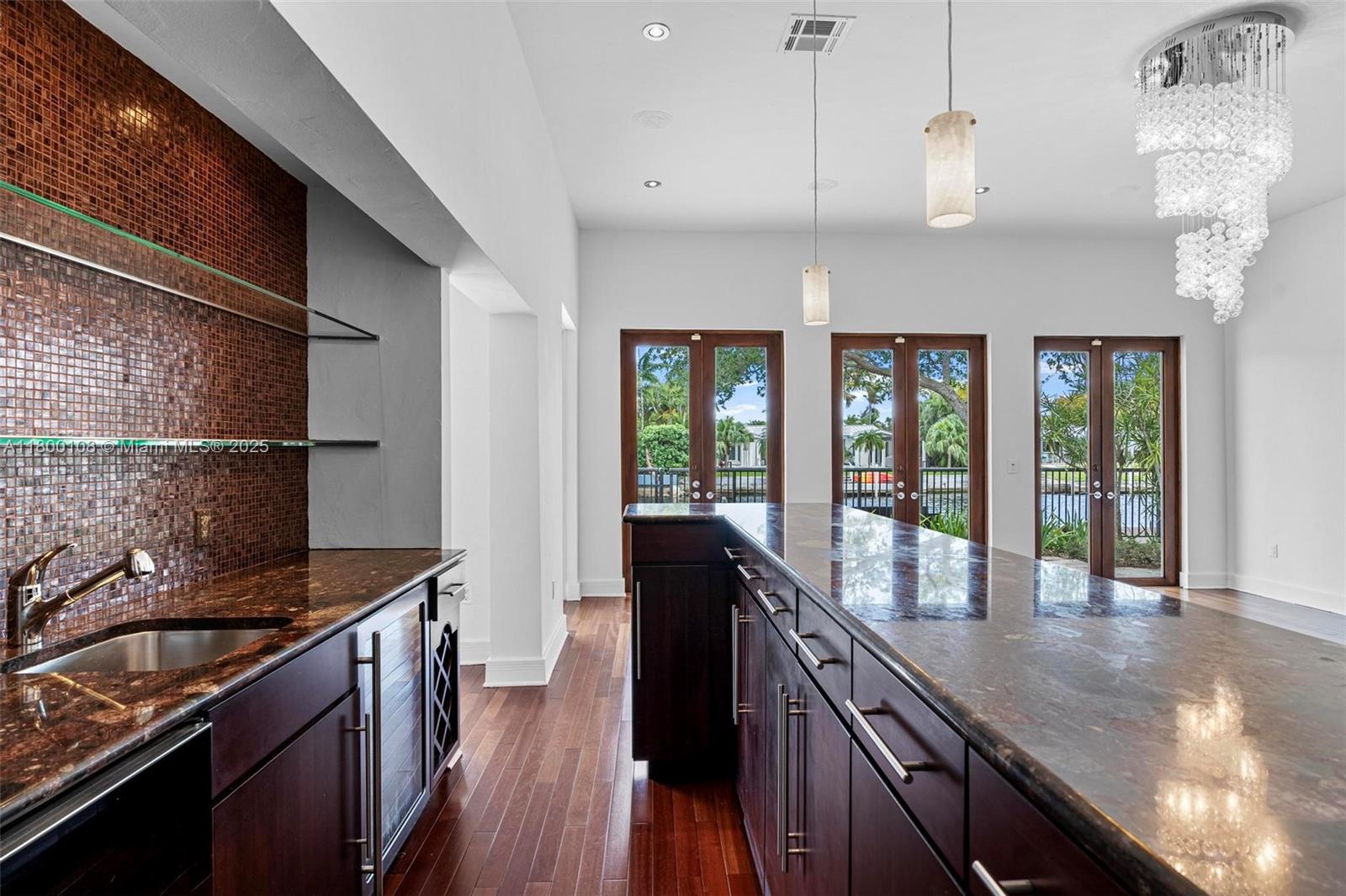 12605 Cyprus Road North Miami, FL 33181 - Photo 16 of 60 a kitchen with granite countertop a sink a stove and cabinets
