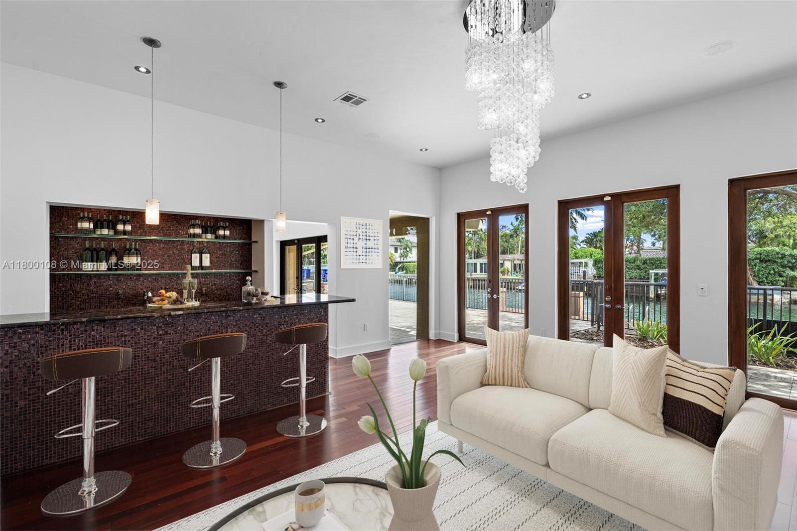 12605 Cyprus Road North Miami, FL 33181 - Photo 18 of 60 a living room with furniture a large window and a flat screen tv
