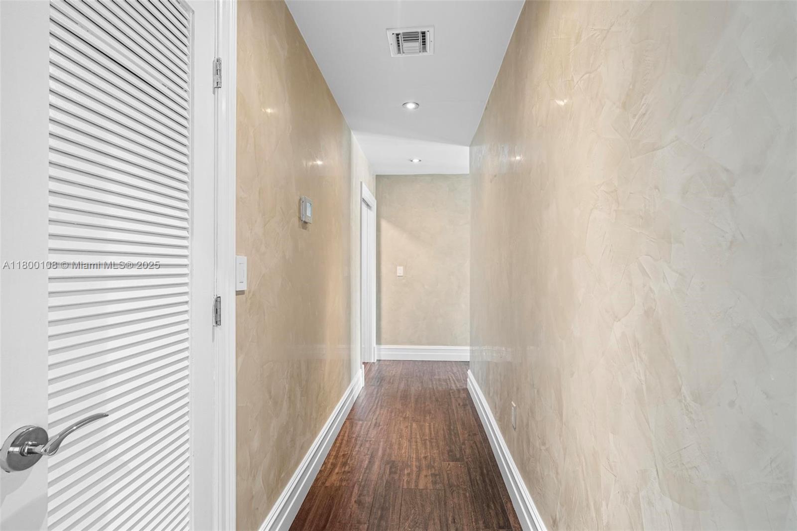 12605 Cyprus Road North Miami, FL 33181 - Photo 27 of 60 a view of a hallway with wooden floor