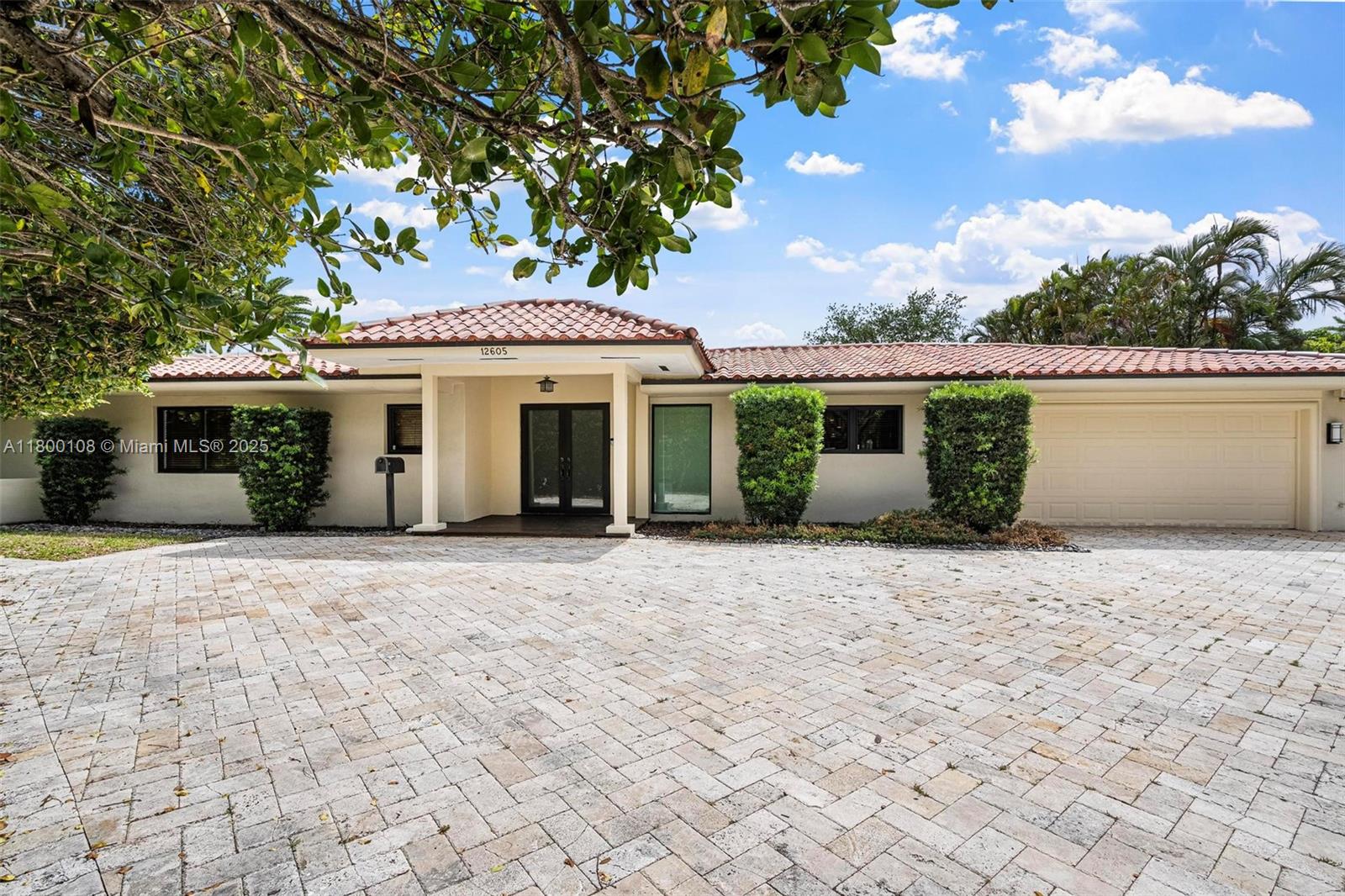 12605 Cyprus Road North Miami, FL 33181 - Photo 3 of 60 a view of a white house with a yard and large tree
