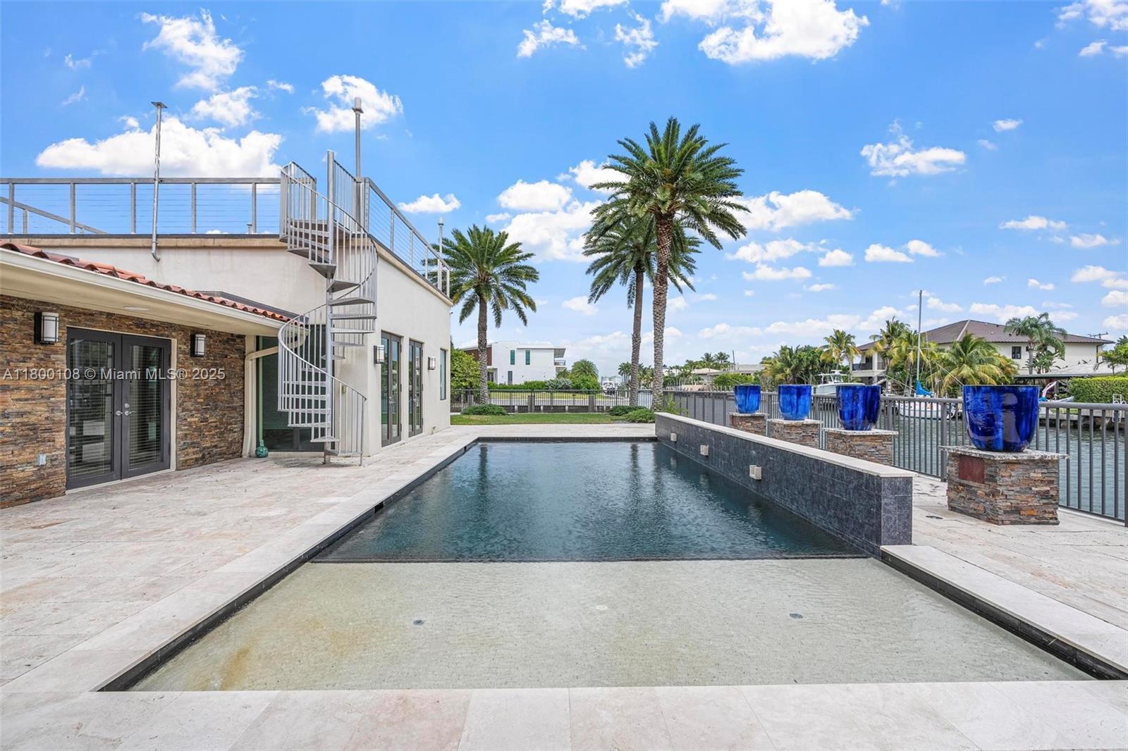 12605 Cyprus Road North Miami, FL 33181 - Photo 36 of 60 a view of a swimming pool and a lounge chair