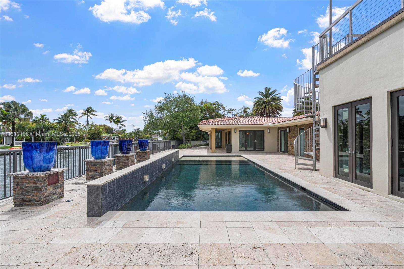 12605 Cyprus Road North Miami, FL 33181 - Photo 37 of 60 a view of a house with swimming pool and sitting area