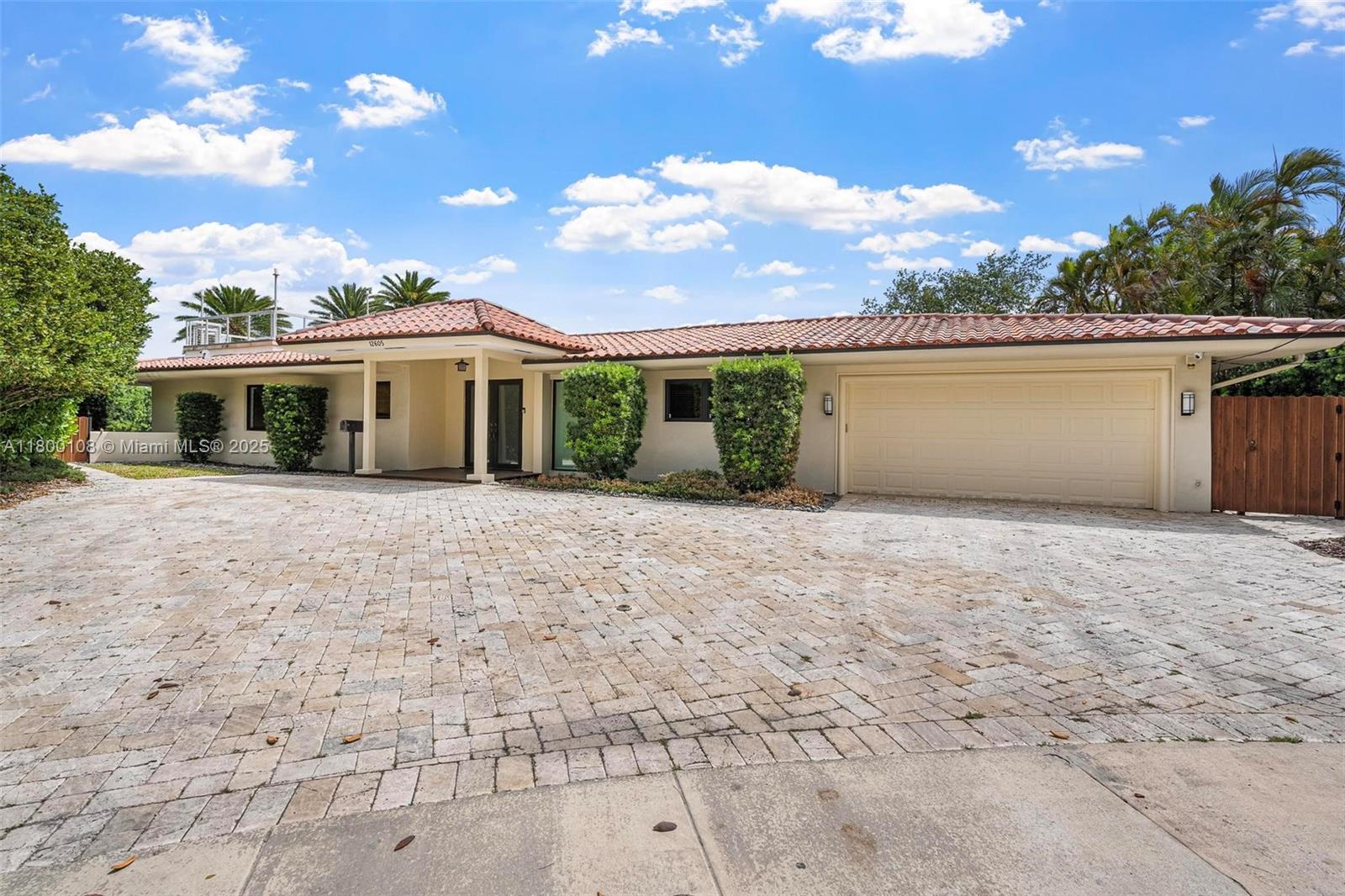 12605 Cyprus Road North Miami, FL 33181 - Photo 4 of 60 front view of a house with a yard
