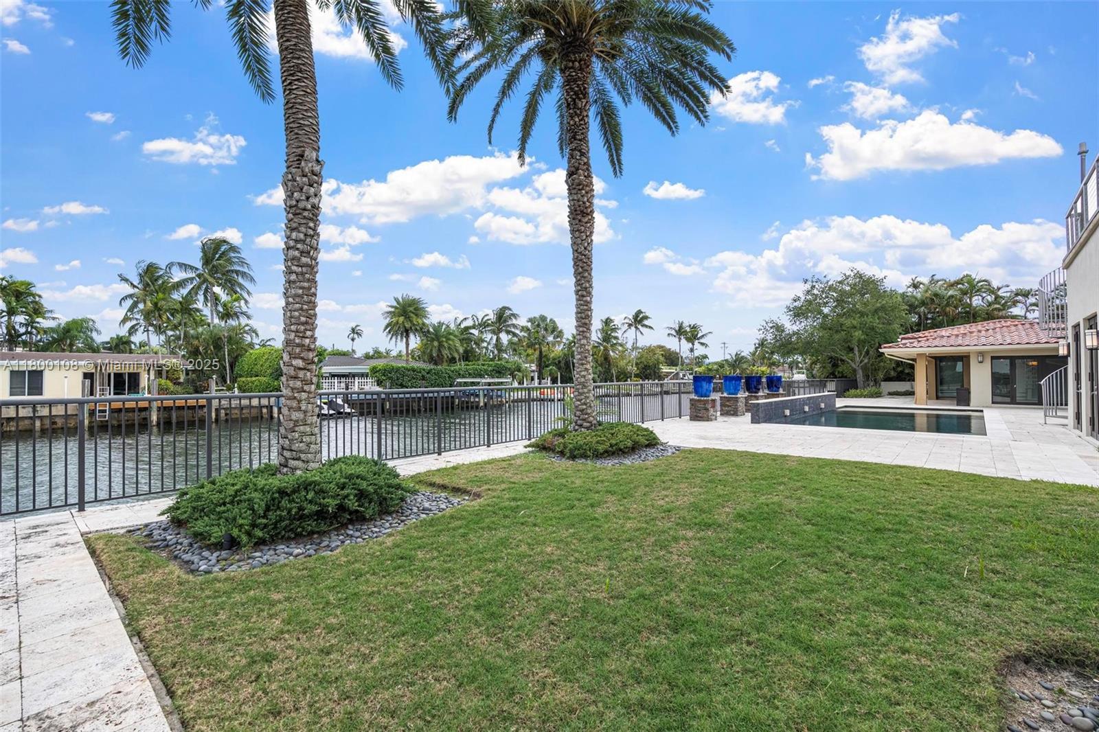 12605 Cyprus Road North Miami, FL 33181 - Photo 41 of 60 a view of a lake with a house