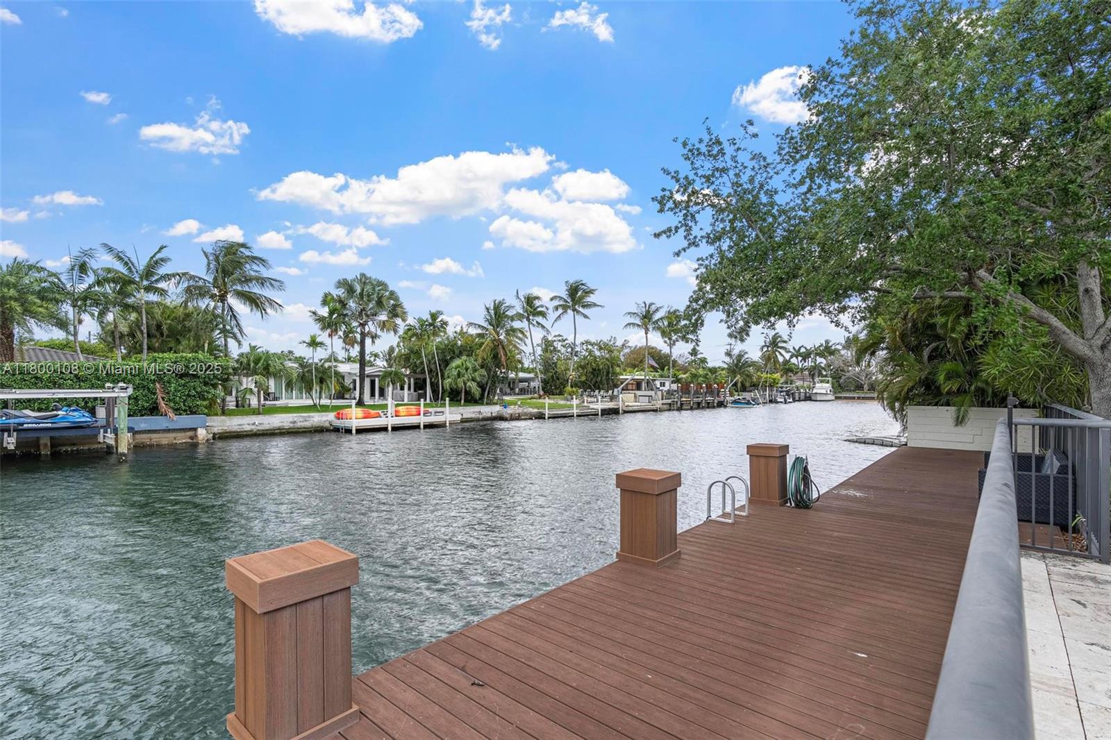 12605 Cyprus Road North Miami, FL 33181 - Photo 44 of 60 a view of a lake with boats and trees in the background