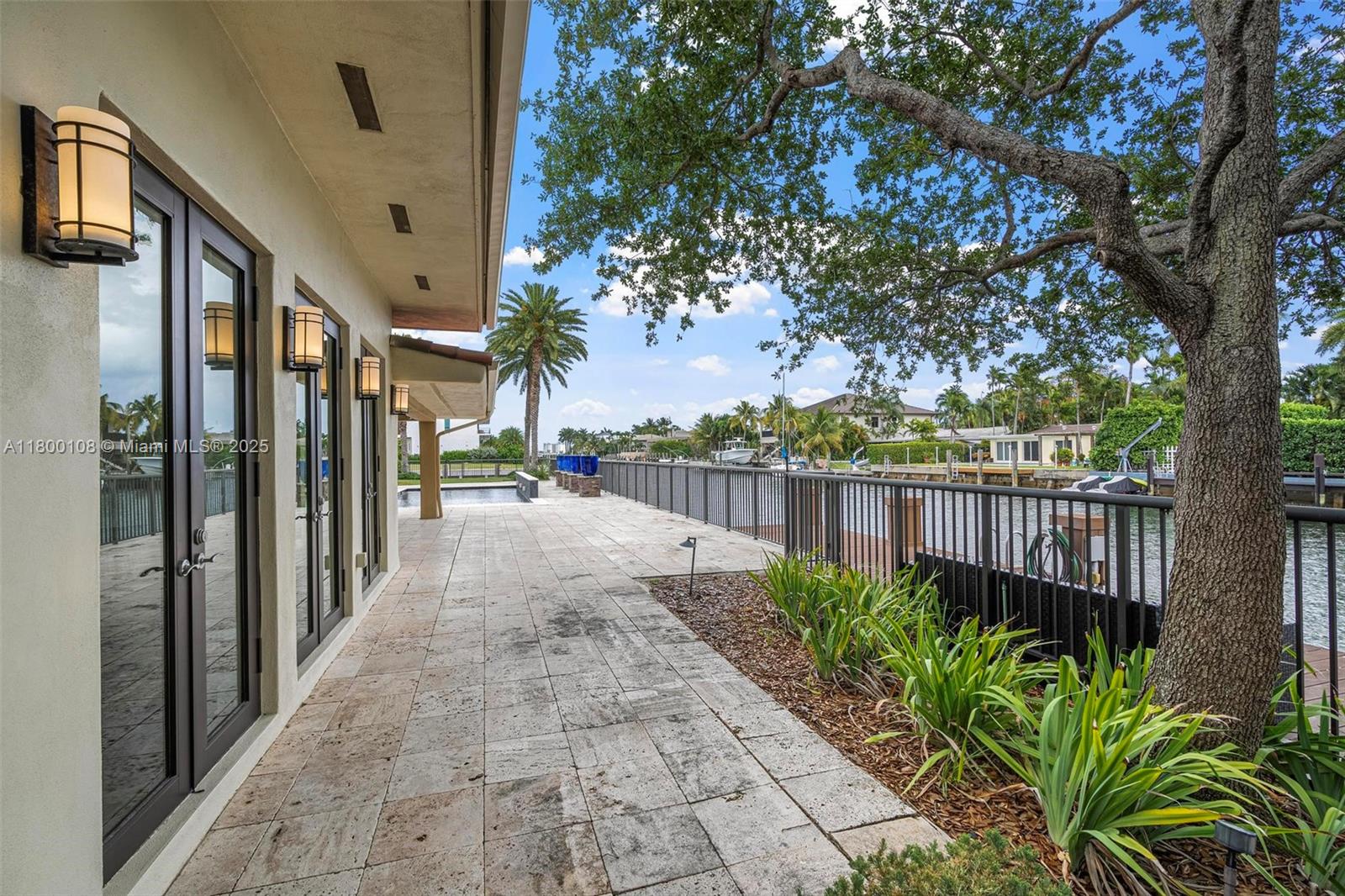 12605 Cyprus Road North Miami, FL 33181 - Photo 48 of 60 a view of a pathway with a small yard next to a building