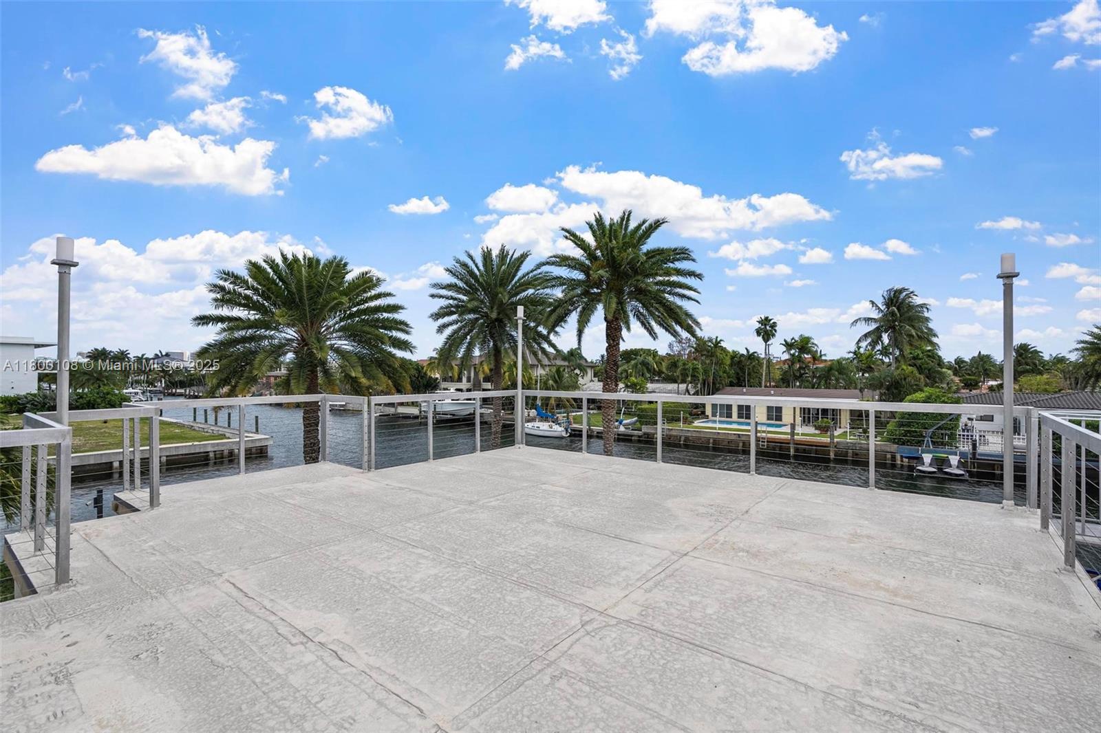 12605 Cyprus Road North Miami, FL 33181 - Photo 50 of 60 a view of a swimming pool with a table and chairs