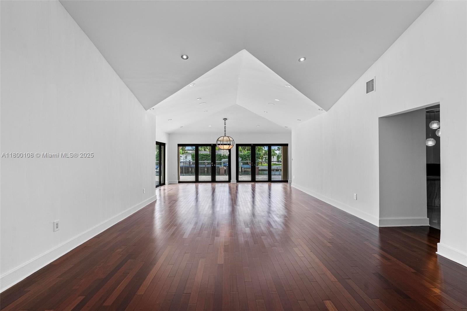 12605 Cyprus Road North Miami, FL 33181 - Photo 7 of 60 a view of an empty room with wooden floor and a window