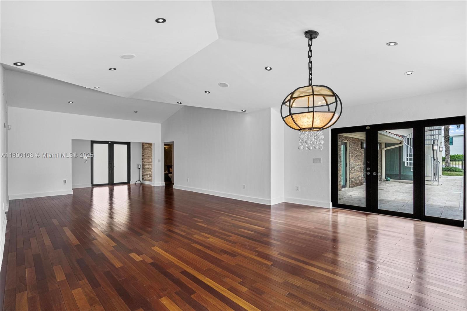 12605 Cyprus Road North Miami, FL 33181 - Photo 10 of 60 a view of an empty room with wooden floor and a window