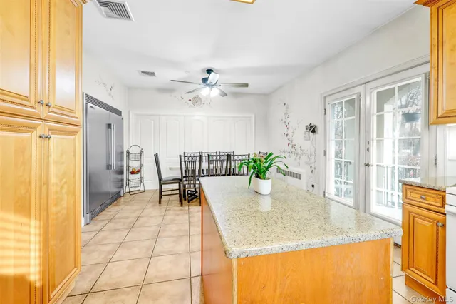 a view of a dining room with furniture and a chandelier