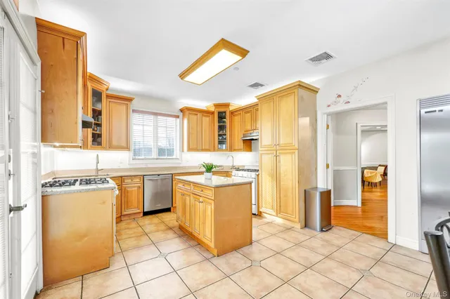 a kitchen with a refrigerator a stove top oven and a sink