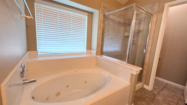 a white bath tub sitting next to a window