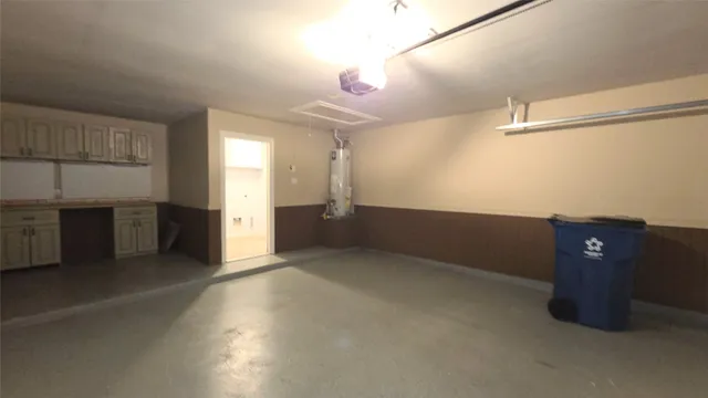 an empty room with a fireplace and cabinet