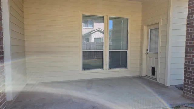 a view of a small space with wooden door