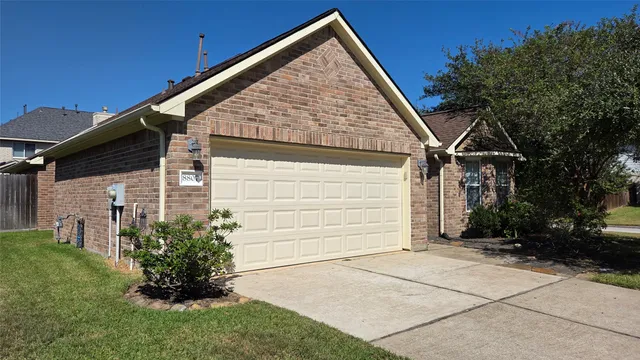 a view of house with backyard and garden
