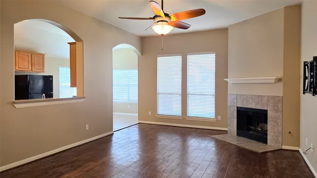 a view of an empty room with window and fireplace