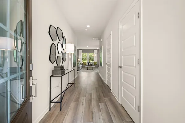 a view of hallway with wooden floor