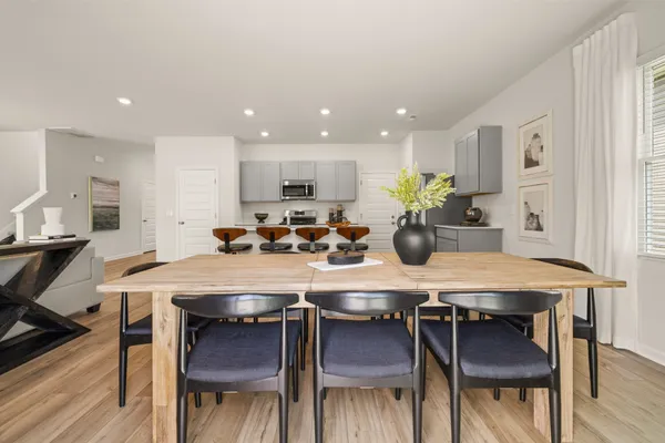 a living room with furniture and kitchen view
