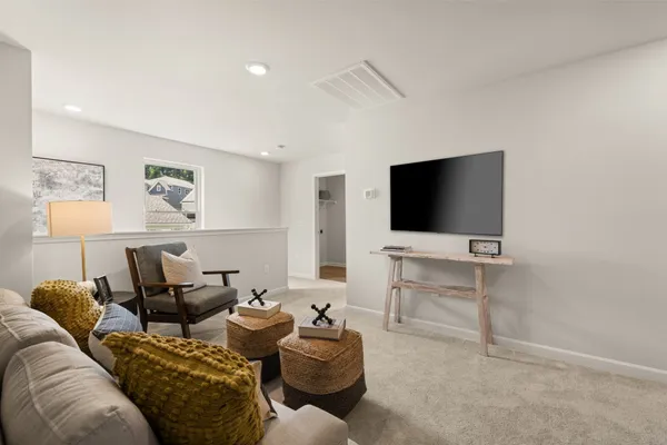 a living room with furniture and wooden floor