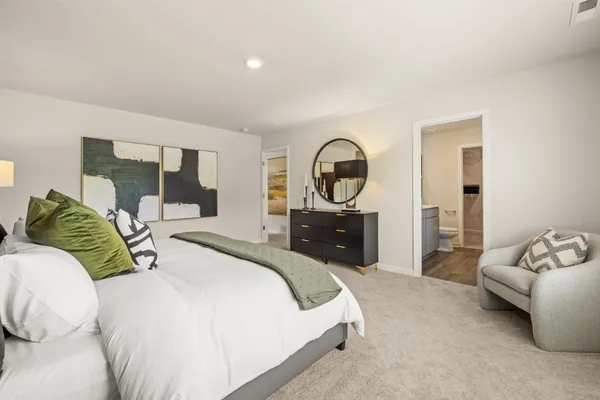 a bed sitting in a bedroom next to a window