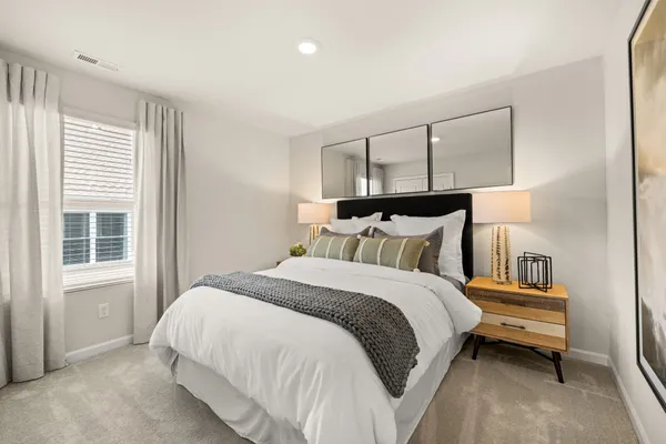 a bedroom with a bed and lamp with window