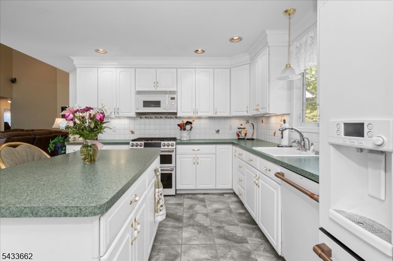 15 Bracken Hill Road Hamburg, NJ 07419 - Photo 15 of 44 a kitchen with granite countertop a sink stove and cabinets