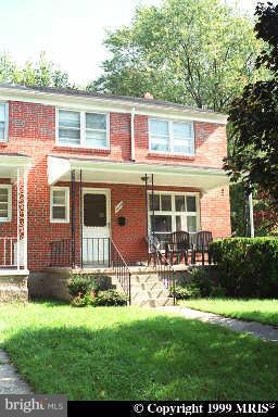 1229 Knightswood Road Baltimore, MD 21239 - Photo 1 of 1 front view of a house with a yard