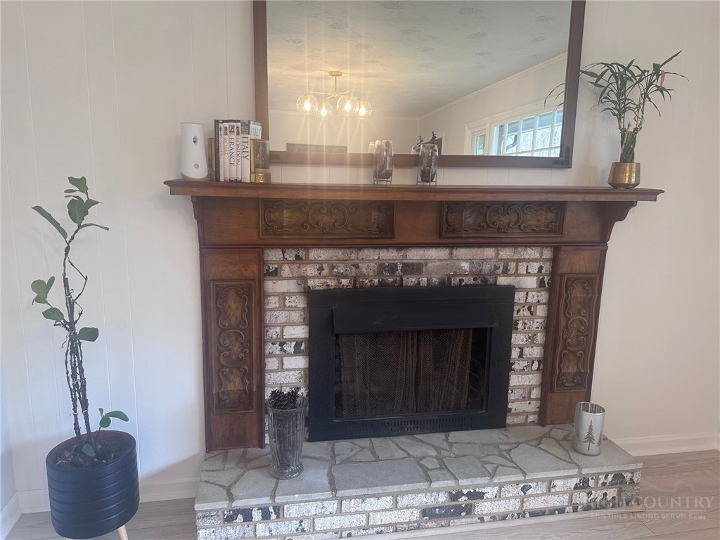 410 Cook Street Jefferson, NC 28640 - Photo 10 of 16 a fireplace with a vase on top of it